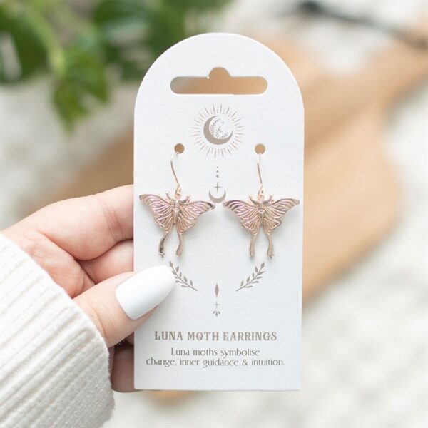 Luna moth earrings displayed on a card, symbolizing change, intuitiveness, and inner guidance.