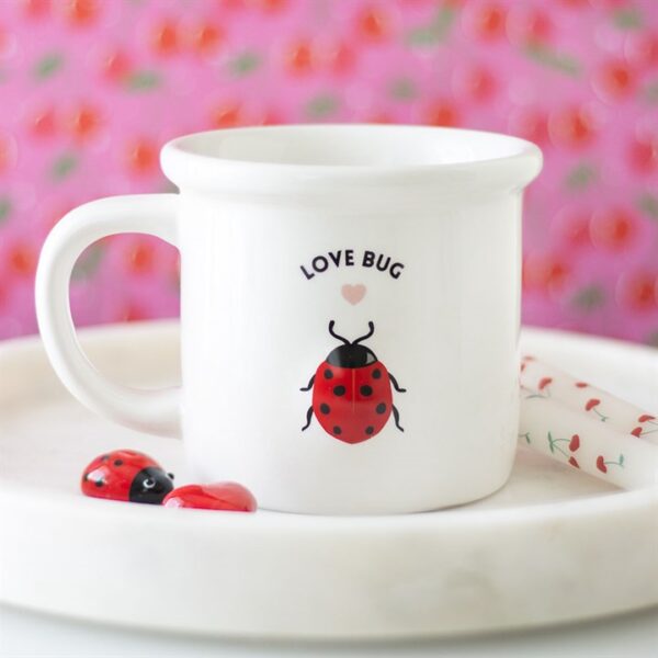 A cute white mug featuring a ladybug and the text "LOVE BUG" with a pink background.