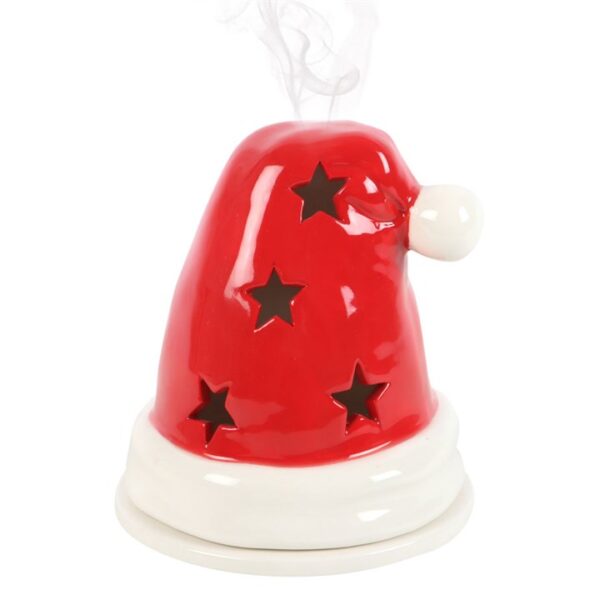 A festive ceramic Santa hat air freshener, emitting smoke and adorned with black stars.