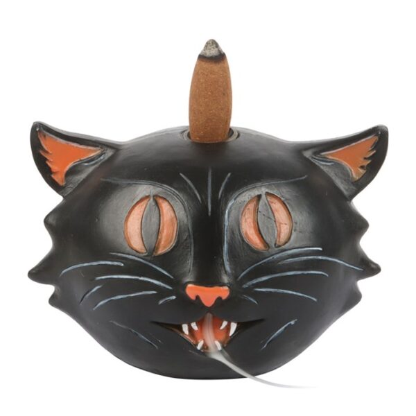 A ceramic black cat incense holder with stylized features and a burning incense cone on top.