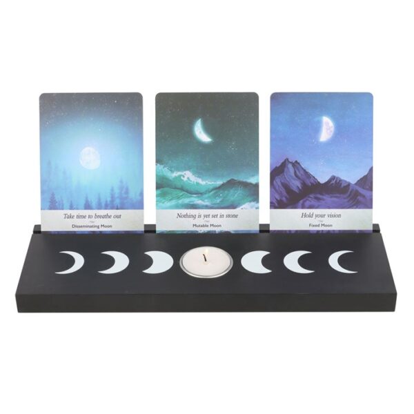 Moon phase display with cards for different lunar stages and a candle holder in the center.