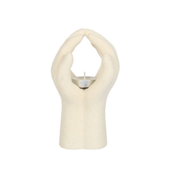 A decorative candle holder shaped like two hands, elegantly crafted to hold a tea light.